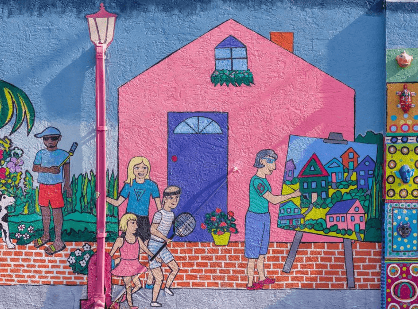 brightly painted mural in village of the arts